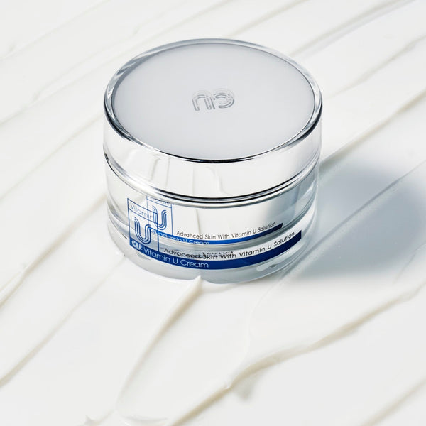cu vitamin u cream moisturizer sitting on cream front view.