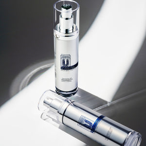 top view angle of two cu vitamin u serum with one laid down.