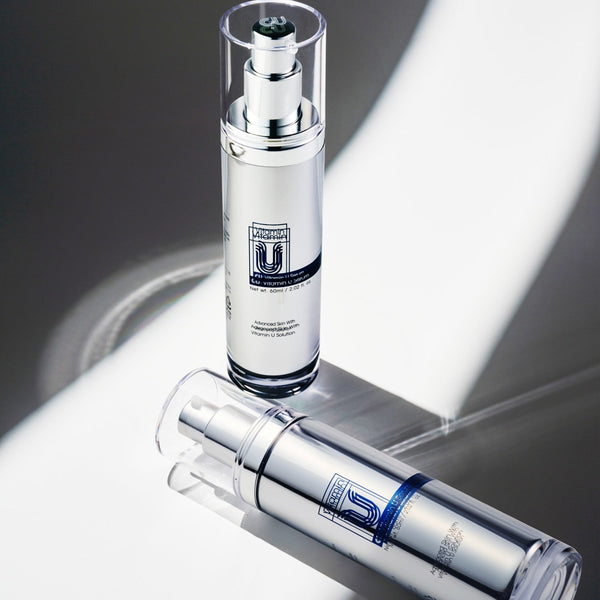 top view angle of two cu vitamin u serum with one laid down.