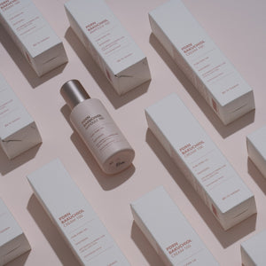 dr solution pdrn bakuchiol ampoule 100 serum bottle on a light pink background with boxes.