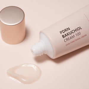 PDRN Bakuchiol Cream 100 tube with cream on a beige background.