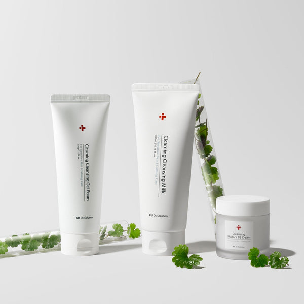 Three dr solution skincare products on a light gray background with green leaves.